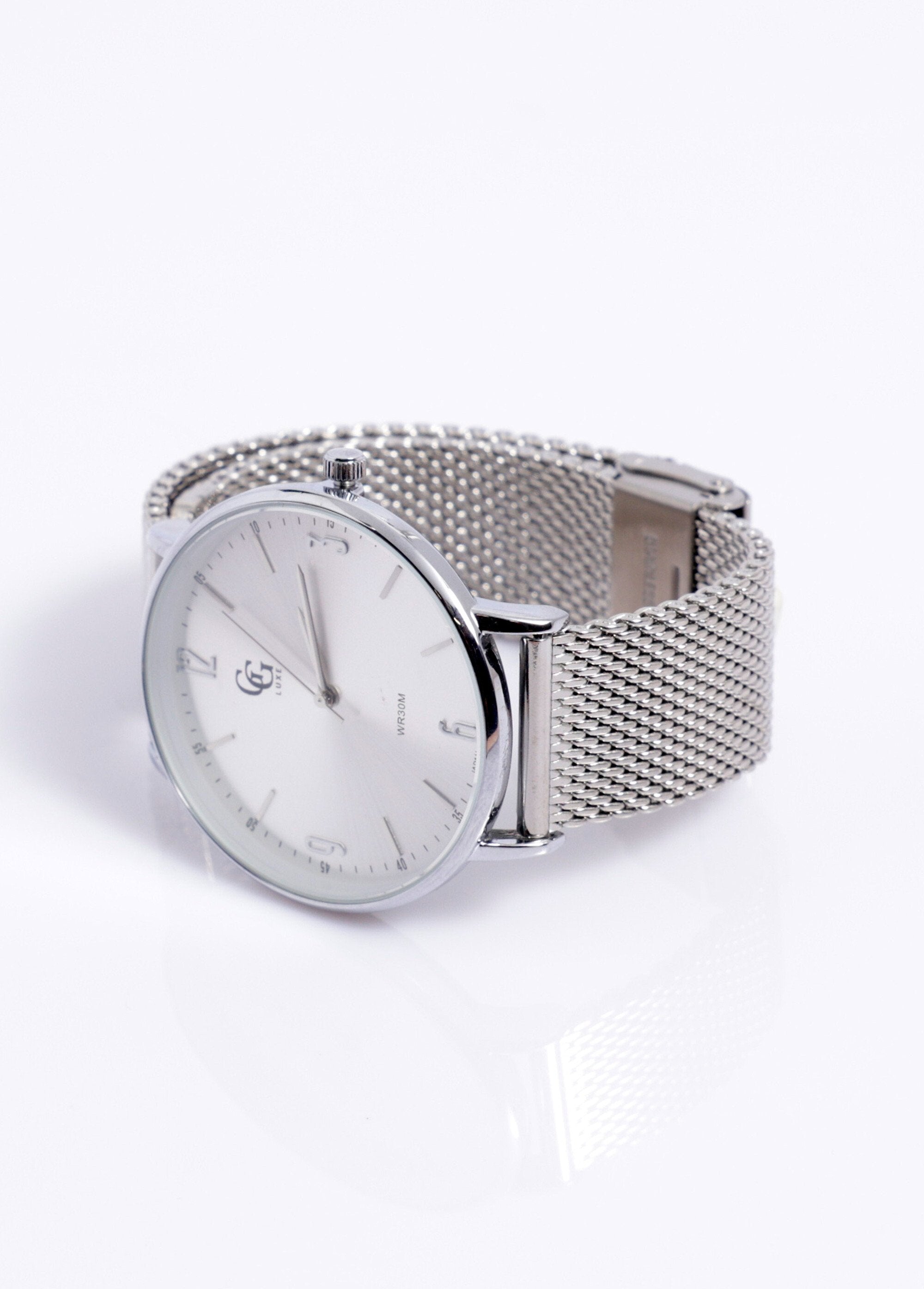 Reloj_redondo_con_brazalete_de_malla_milanesa,_1G_Dinero_blanco_DE1_slim